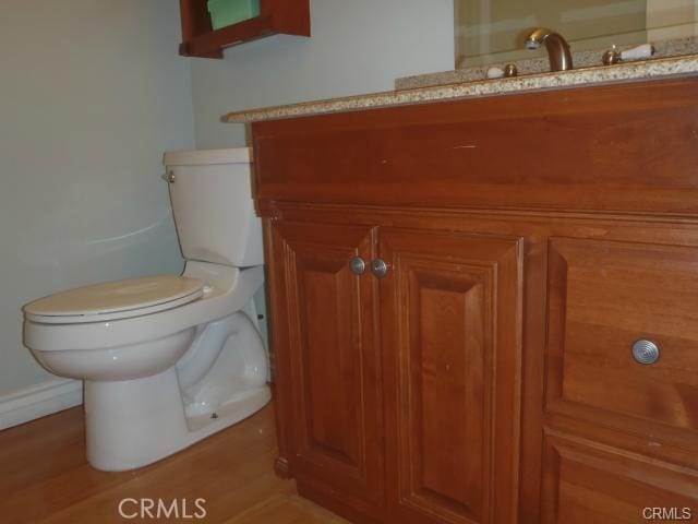 11459 Shippigan Way, Cypress, CA 90630 - half bath featuring vanity, toilet, wood finished floors, and baseboards
