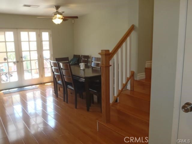 11459 Shippigan Way, Cypress, CA 90630 - dining room featuring french doors, stairway, ceiling fan, and wood finished floors