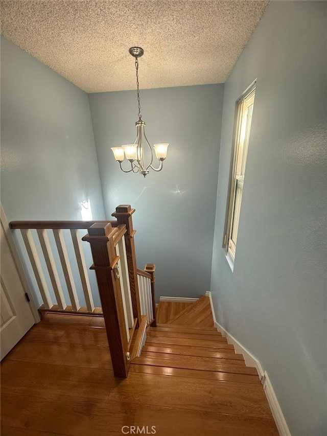 11459 Shippigan Way, Cypress, CA 90630 - stairway with wood finished floors, a chandelier, and a textured ceiling