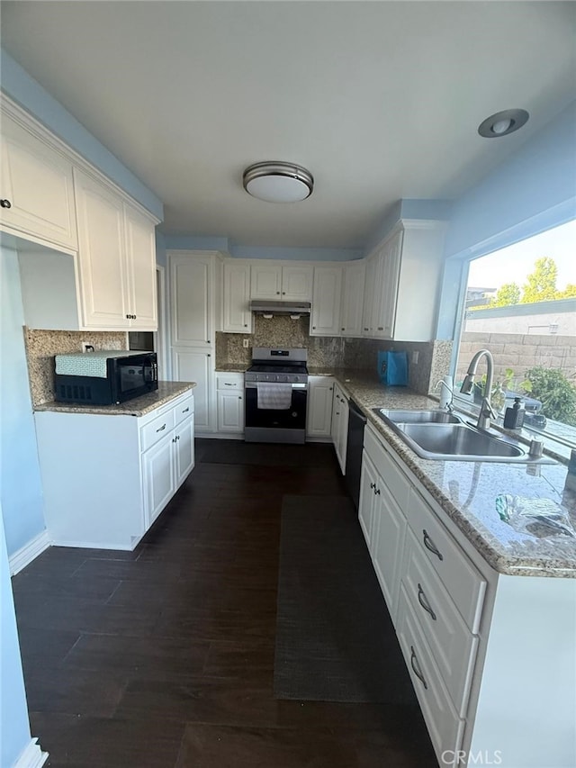 11459 Shippigan Way, Cypress, CA 90630 - kitchen with stainless steel electric range oven, black dishwasher, under cabinet range hood, white cabinets, and tasteful backsplash