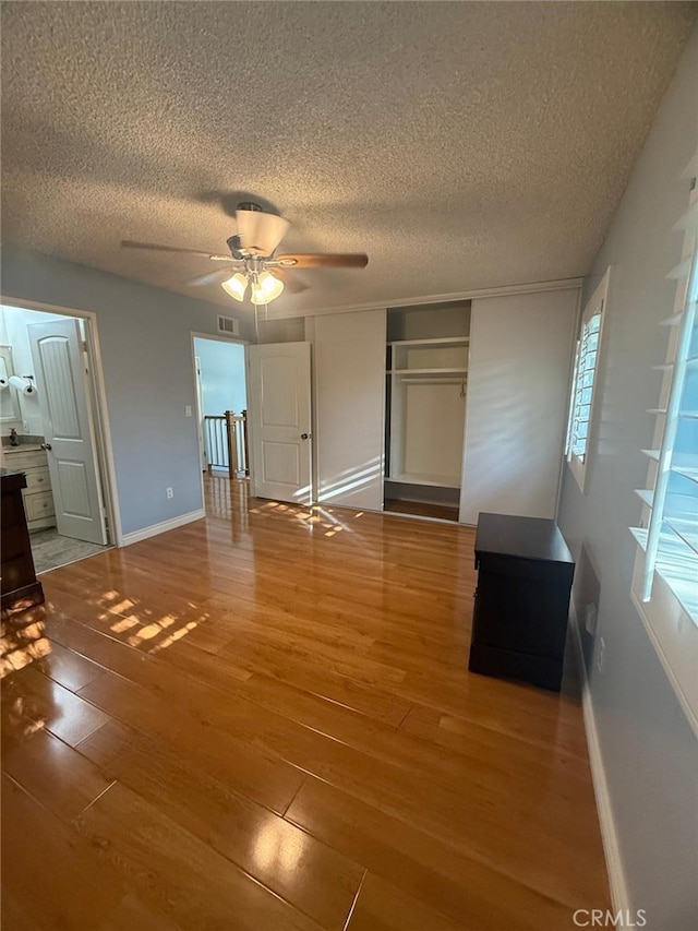 11459 Shippigan Way, Cypress, CA 90630 - unfurnished bedroom featuring light wood finished floors, a textured ceiling, a closet, and a ceiling fan