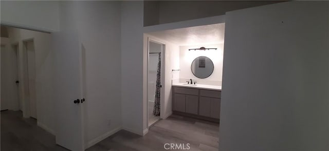 8814 Knollwood Pl, Rancho Cucamonga, CA 91730 - bathroom with vanity, wood finished floors, a shower, and baseboards