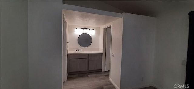 8814 Knollwood Pl, Rancho Cucamonga, CA 91730 - bathroom with wood finished floors, vanity, and baseboards