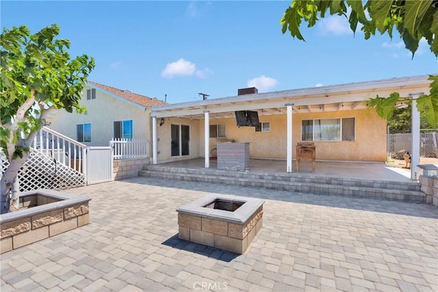 18064 Cajon St, Hesperia, CA 92345 - back of house with a fire pit, stucco siding, and a patio