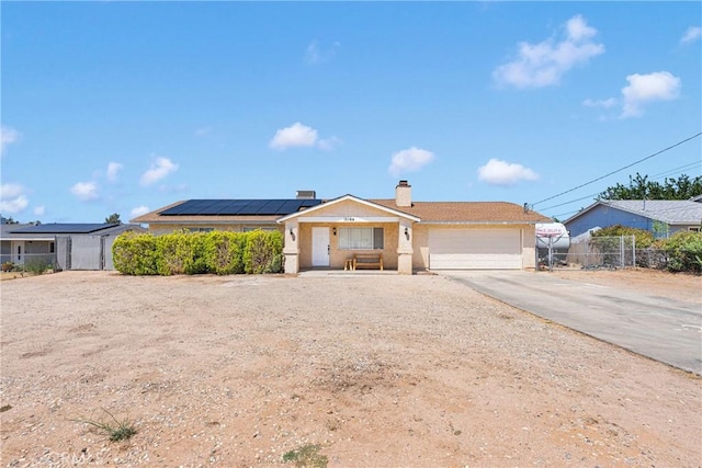 18064 Cajon St, Hesperia, CA 92345 - single story home with roof mounted solar panels, a chimney, a garage, and driveway