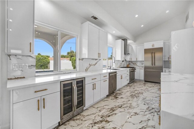 9743 Monogram Ave, Northridge, CA 91343 - kitchen with beverage cooler, appliances with stainless steel finishes, healthy amount of natural light, a sink, and lofted ceiling