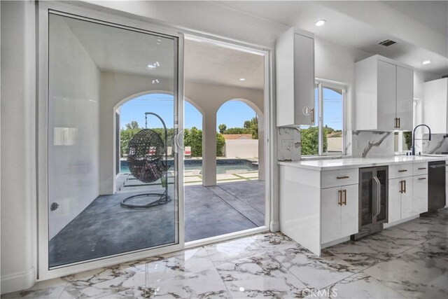 9743 Monogram Ave, Northridge, CA 91343 - kitchen with wine cooler, light countertops, white cabinets, recessed lighting, and dishwasher