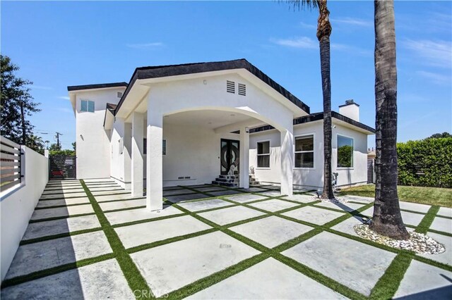 9743 Monogram Ave, Northridge, CA 91343 - modern home featuring stucco siding, a chimney, and a patio