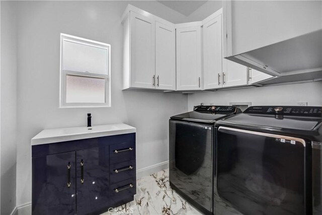 9743 Monogram Ave, Northridge, CA 91343 - laundry room featuring light marble finish flooring, independent washer and dryer, cabinet space, and baseboards