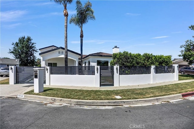 9743 Monogram Ave, Northridge, CA 91343 - view of front of house with a fenced front yard, a gate, a chimney, and stucco siding