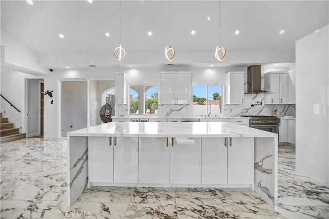 9743 Monogram Ave, Northridge, CA 91343 - kitchen featuring wall chimney range hood, white cabinets, decorative backsplash, light marble finish floors, and a large island