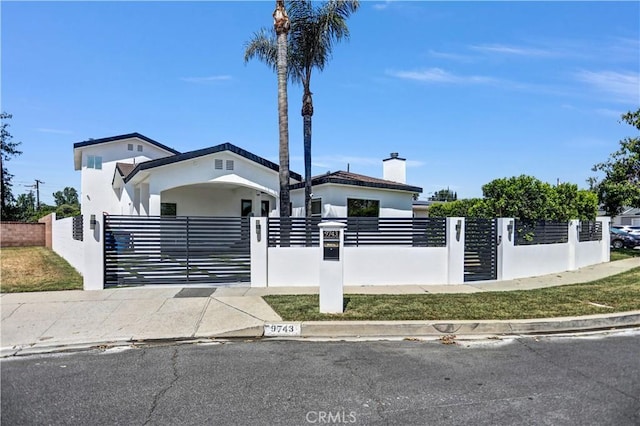 9743 Monogram Ave, Northridge, CA 91343 - view of front of property with a fenced front yard, a chimney, stucco siding, and a gate