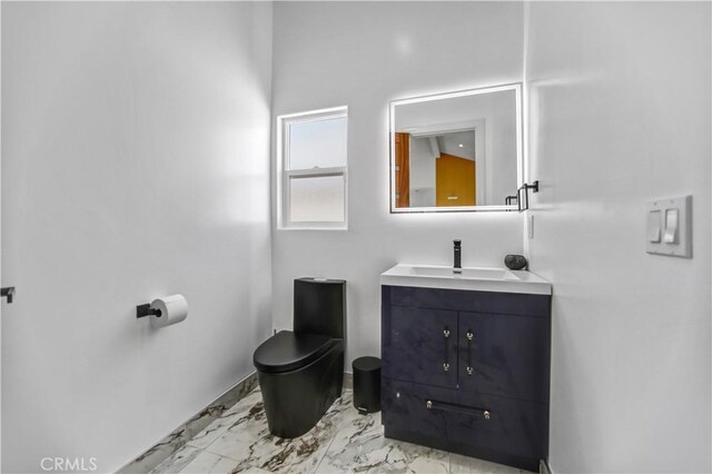 9743 Monogram Ave, Northridge, CA 91343 - bathroom featuring marble finish flooring, vanity, toilet, and baseboards