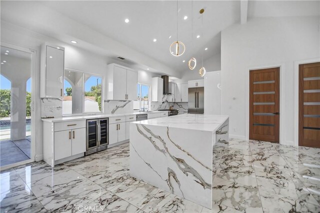 9743 Monogram Ave, Northridge, CA 91343 - kitchen with beverage cooler, white cabinets, a center island, recessed lighting, and wall chimney range hood