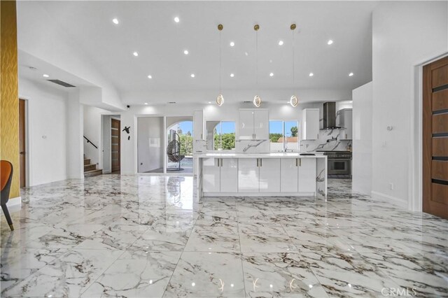 9743 Monogram Ave, Northridge, CA 91343 - kitchen with wall chimney range hood, stainless steel range oven, white cabinetry, light countertops, and a spacious island