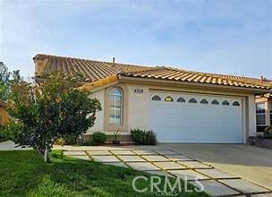 1041 Cypress Point Dr, Banning, CA 92220 - mediterranean / spanish house featuring driveway, a garage, and a tile roof