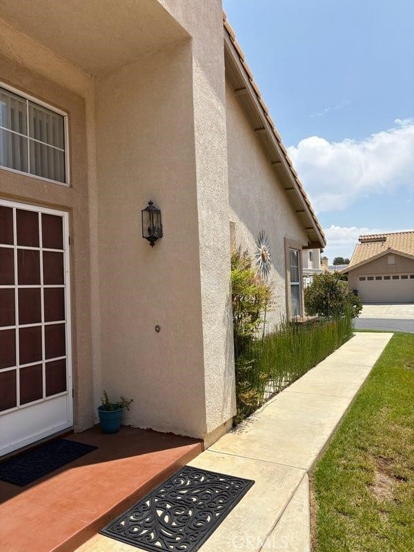 1041 Cypress Point Dr, Banning, CA 92220 - entrance to property with stucco siding