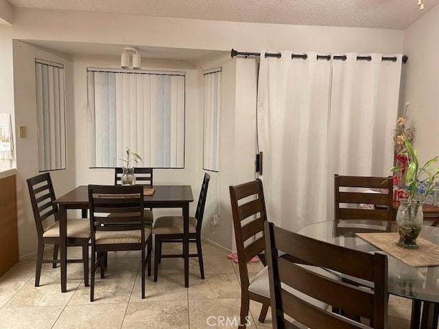 1041 Cypress Point Dr, Banning, CA 92220 - dining room with light tile patterned flooring and a textured ceiling
