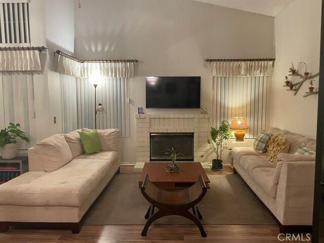 1041 Cypress Point Dr, Banning, CA 92220 - living room featuring wood finished floors and a brick fireplace
