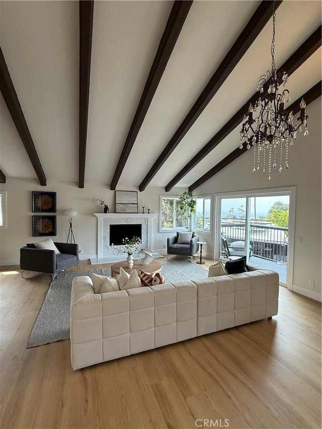 2838 Lambert Dr, Los Angeles, CA 90068 - living area featuring baseboards, a chandelier, light wood-style floors, and a high end fireplace