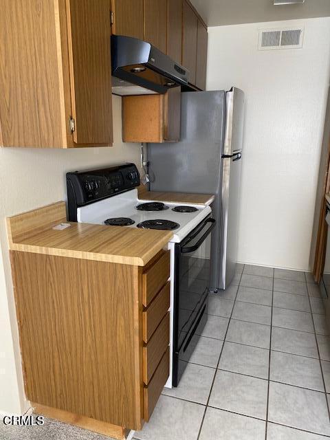 330 S Mentor Ave Unit 233, Pasadena, CA 91106 - kitchen featuring extractor fan, electric stove, light countertops, and light tile patterned flooring