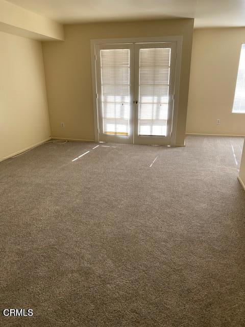 330 S Mentor Ave Unit 233, Pasadena, CA 91106 - carpeted empty room with baseboards and french doors