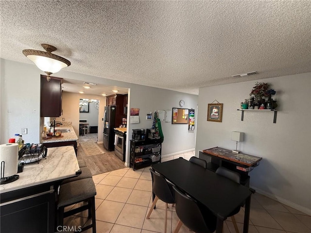 2651 Annapolis Cir, San Bernardino, CA 92408 - dining room with a textured ceiling and light tile patterned floors