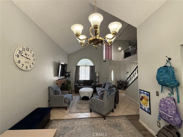 2651 Annapolis Cir, San Bernardino, CA 92408 - living room with stairs, a chandelier, tile patterned flooring, high vaulted ceiling, and baseboards