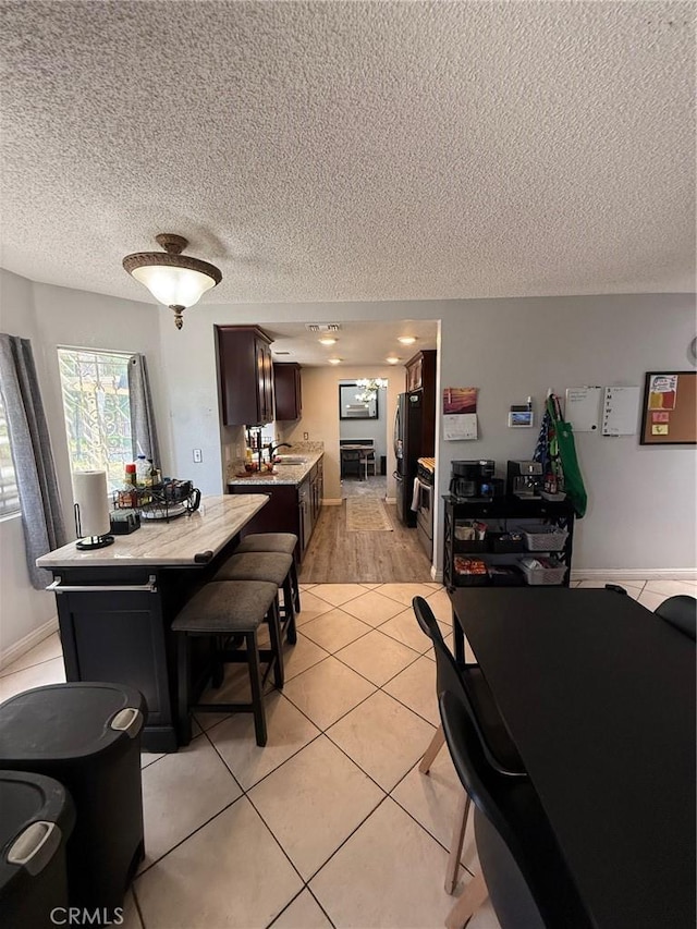 2651 Annapolis Cir, San Bernardino, CA 92408 - dining area with a textured ceiling and light tile patterned floors