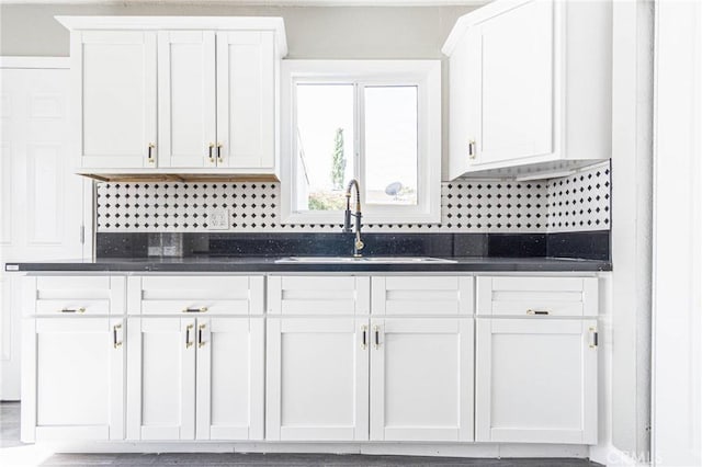 2008 Sequoia Dr, Barstow, CA 92311 - kitchen featuring dark countertops, a sink, and white cabinets