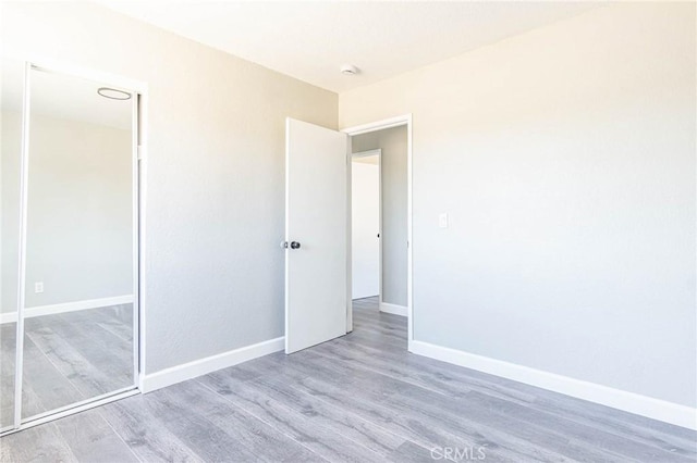2008 Sequoia Dr, Barstow, CA 92311 - unfurnished bedroom with wood finished floors, baseboards, and a closet