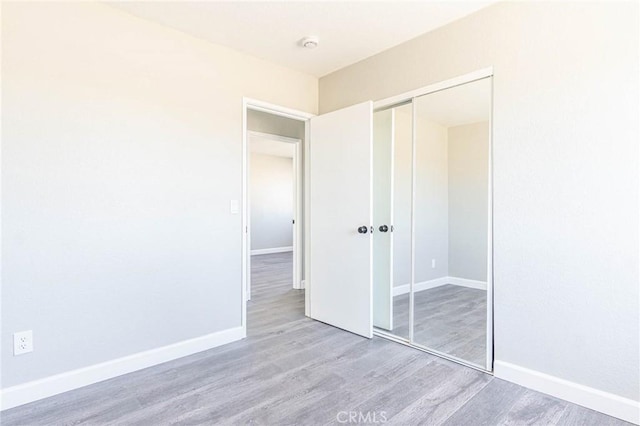 2008 Sequoia Dr, Barstow, CA 92311 - unfurnished bedroom with wood finished floors, a closet, and baseboards