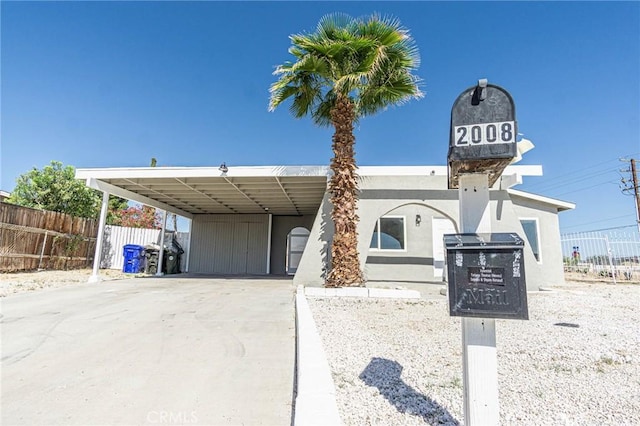 2008 Sequoia Dr, Barstow, CA 92311 - view of front of home featuring concrete driveway, stucco siding, and a carport