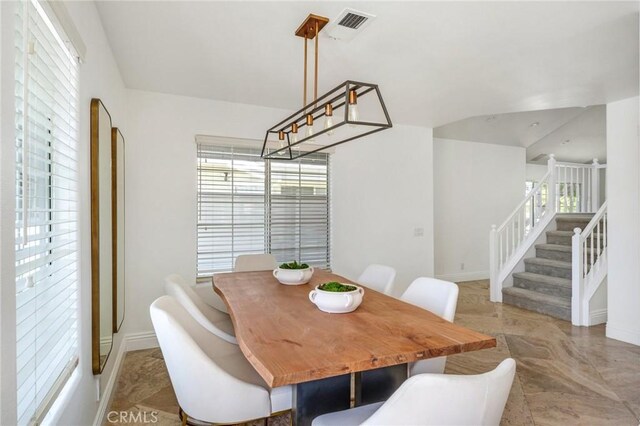 245 Palmer St, Costa Mesa, CA 92627 - dining space featuring stairway, baseboards, and vaulted ceiling