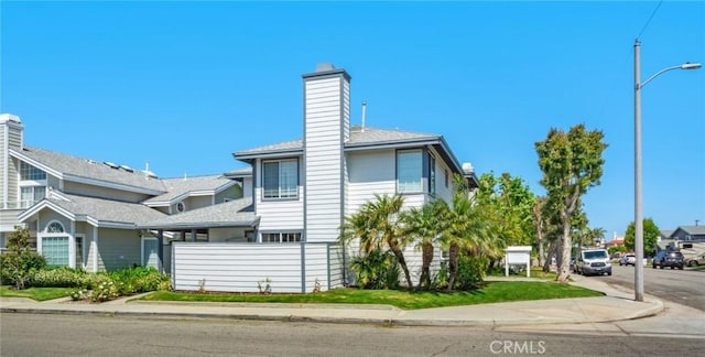 245 Palmer St, Costa Mesa, CA 92627 - view of side of home featuring a chimney and a shingled roof