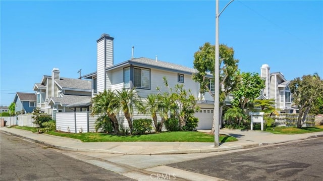 245 Palmer St, Costa Mesa, CA 92627 - multi unit property featuring an attached garage, concrete driveway, and a chimney