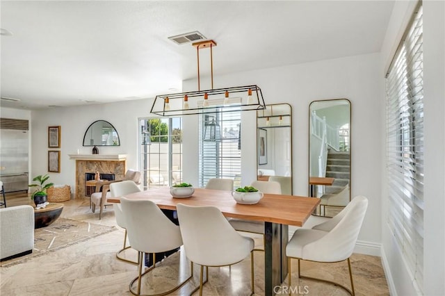 245 Palmer St, Costa Mesa, CA 92627 - dining room with a premium fireplace, stairway, a chandelier, and baseboards