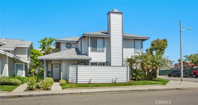 245 Palmer St, Costa Mesa, CA 92627 - view of front of home with a chimney and roof with shingles