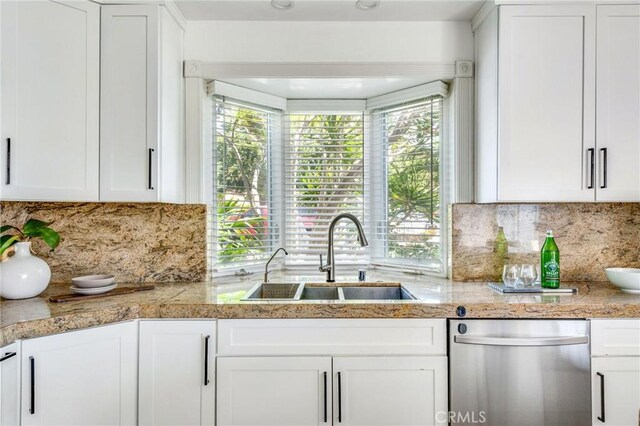 245 Palmer St, Costa Mesa, CA 92627 - kitchen with stainless steel dishwasher, a sink, white cabinets, and healthy amount of natural light