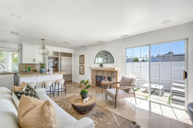 245 Palmer St, Costa Mesa, CA 92627 - living room with a fireplace, baseboards, and light tile patterned floors