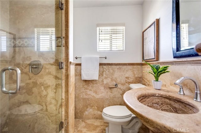 245 Palmer St, Costa Mesa, CA 92627 - bathroom featuring toilet, a sink, tile walls, a shower stall, and wainscoting