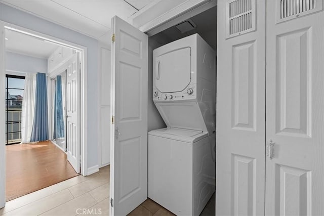 3568 Keystone Ave Unit 8, Los Angeles, CA 90034 - laundry room featuring stacked washing machine and dryer and light tile patterned floors