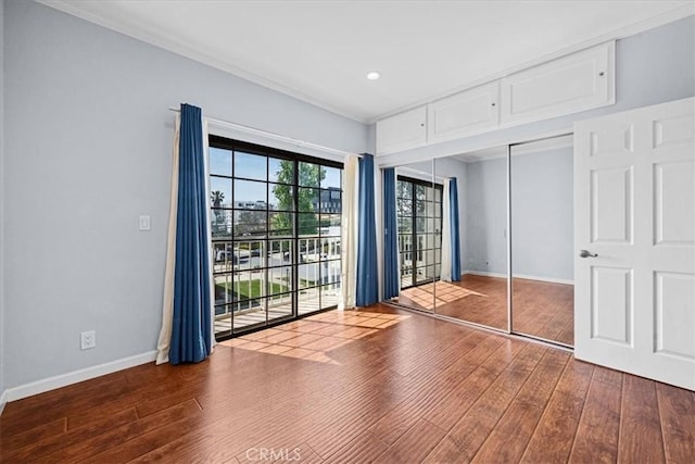 3568 Keystone Ave Unit 8, Los Angeles, CA 90034 - unfurnished bedroom featuring wood finished floors, baseboards, crown molding, access to exterior, and a closet