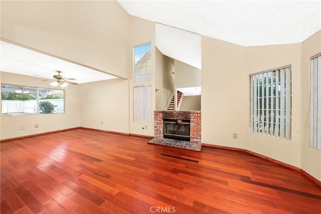 37538 Stonegate Ln, Palmdale, CA 93552 - unfurnished living room with hardwood / wood-style flooring, baseboards, a fireplace, and high vaulted ceiling