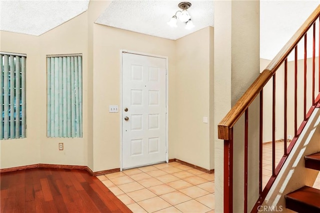 37538 Stonegate Ln, Palmdale, CA 93552 - foyer featuring stairway, baseboards, a textured ceiling, and wood finished floors