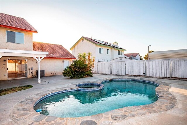 37538 Stonegate Ln, Palmdale, CA 93552 - view of swimming pool with a fenced backyard, a patio area, a pool with connected hot tub, and central air condition unit