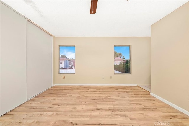 37538 Stonegate Ln, Palmdale, CA 93552 - unfurnished room with light wood-type flooring, a ceiling fan, and baseboards