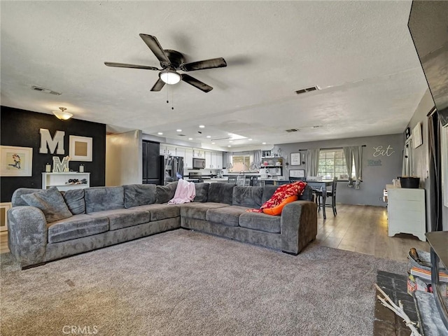 20715 Teton Rd, Apple Valley, CA 92308 - living room featuring ceiling fan, a textured ceiling, carpet flooring, and wood finished floors