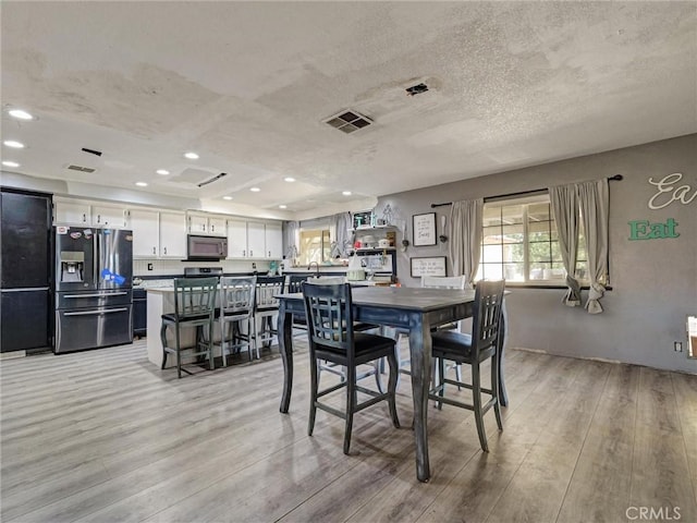 20715 Teton Rd, Apple Valley, CA 92308 - dining area featuring plenty of natural light, light wood-style floors, a textured ceiling, and recessed lighting