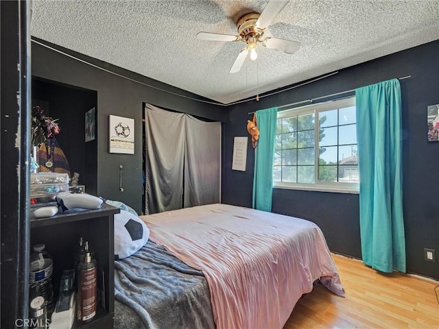 20715 Teton Rd, Apple Valley, CA 92308 - bedroom featuring a textured ceiling, wood finished floors, and a ceiling fan